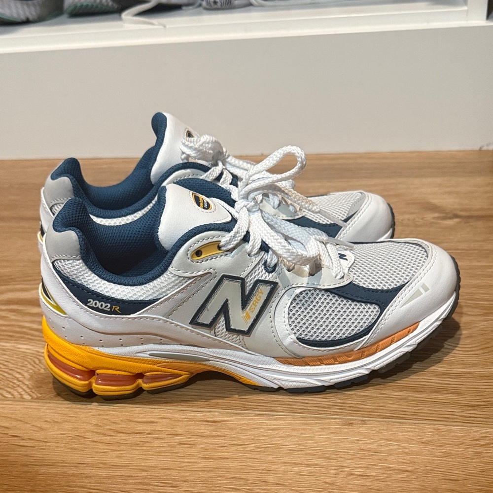 New Balance 2002R White and Blue Sneakers with Yellow Accents